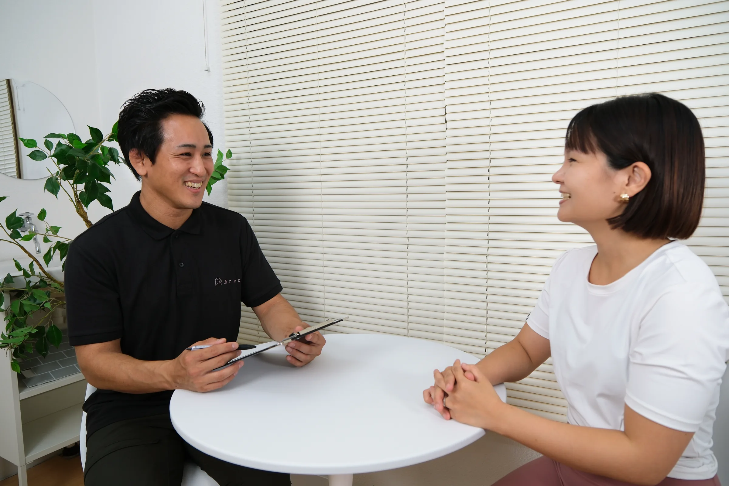 トレーナーとお客様が笑顔で会話している様子
